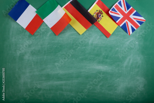 flags of Spain, France, Great Britain, Russia and Italy on the background of the blackboard
