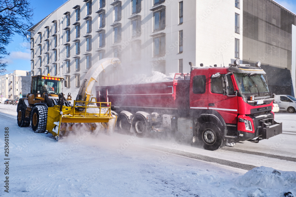Snowplow removing snow in the street Snowplow removing snow in the street