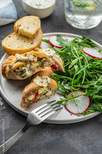Roasted chicken breasts stuffed with mushrooms, green onion, pepper and garnished fresh salad and rocket salad.