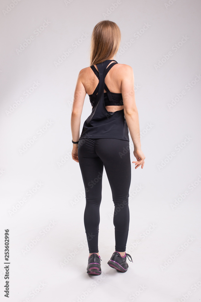 Rear view of sitting sportive woman wearing leggings. Rear view of sitting sportive woman wearing leggings.