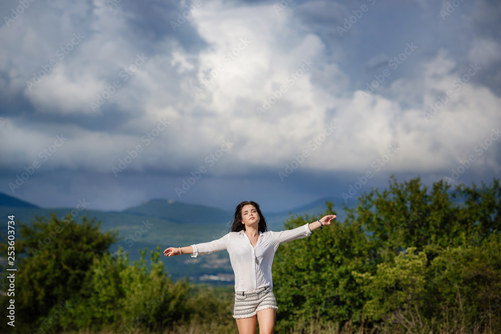Smiling cheerful girl breathes a full breast and enjoys freedom Smiling cheerful girl breathes a full breast and enjoys freedom