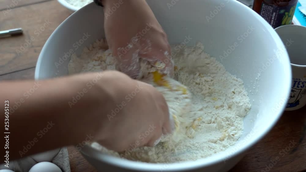 Eggs have just been added to the dough being kneaded. Eggs have just been added to the dough being kneaded.