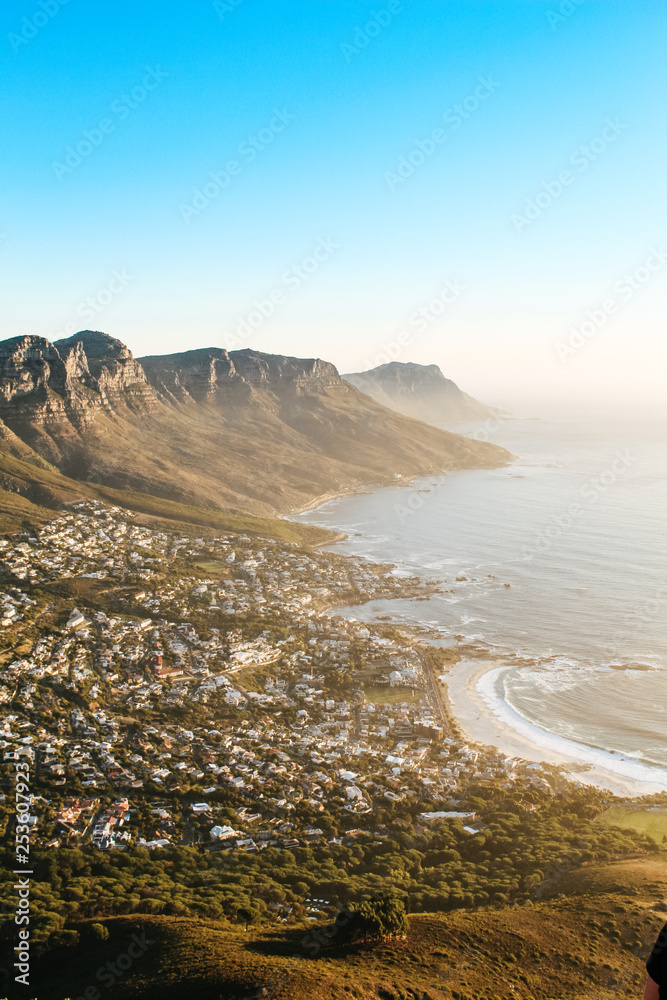 View of the 12 apostles and Camps Bay seen from the peak of Lions Head lookout point at sunset. - obrazy, fototapety, plakaty 