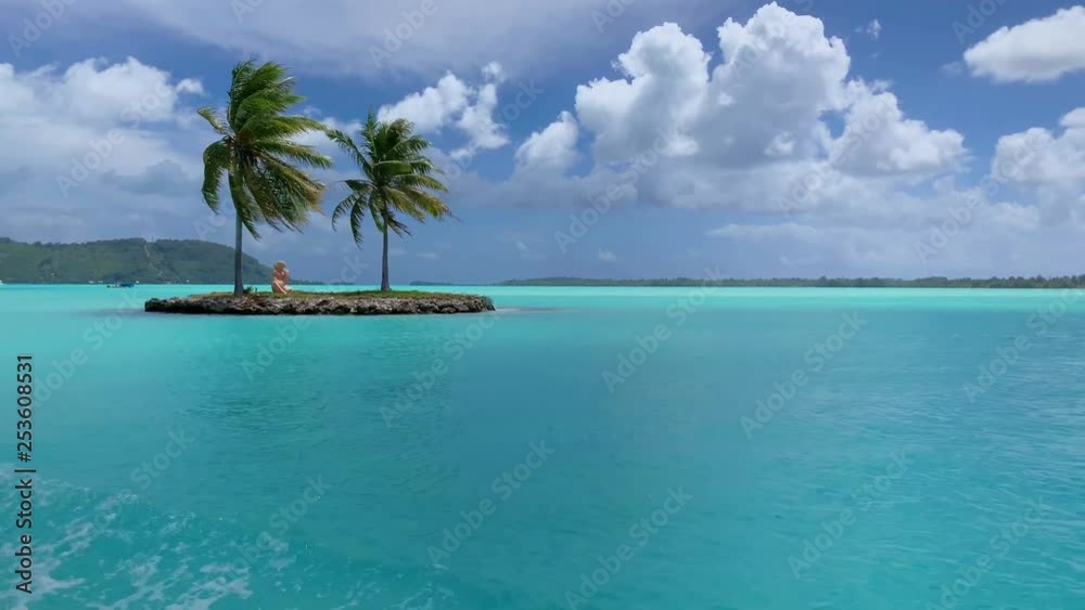 Sailing in turquoise lagoon near a small island with palm trees in front of Bora Bora Airport at Motu Mute. French Polynesia, South Pacific Ocean. Sailing in turquoise lagoon near a small island with palm trees in front of Bora Bora Airport at Motu Mute. French Polynesia, South Pacific Ocean.