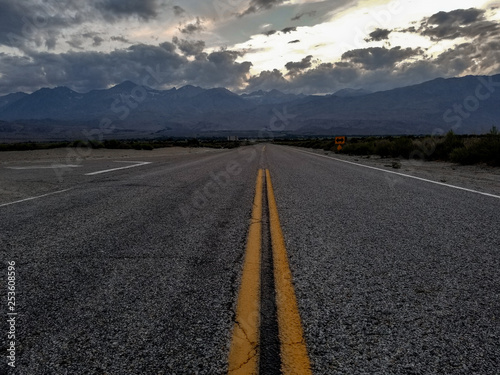 A road headed into the mountains with a curve or vanishing point in the distance