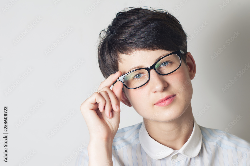 Portrait of a young woman with glasses.