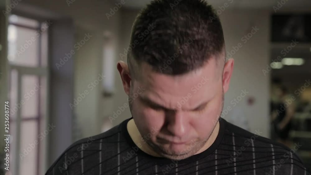 Fat man weighs himself on scales and is surprised. Fat man weighs himself on scales and is surprised.