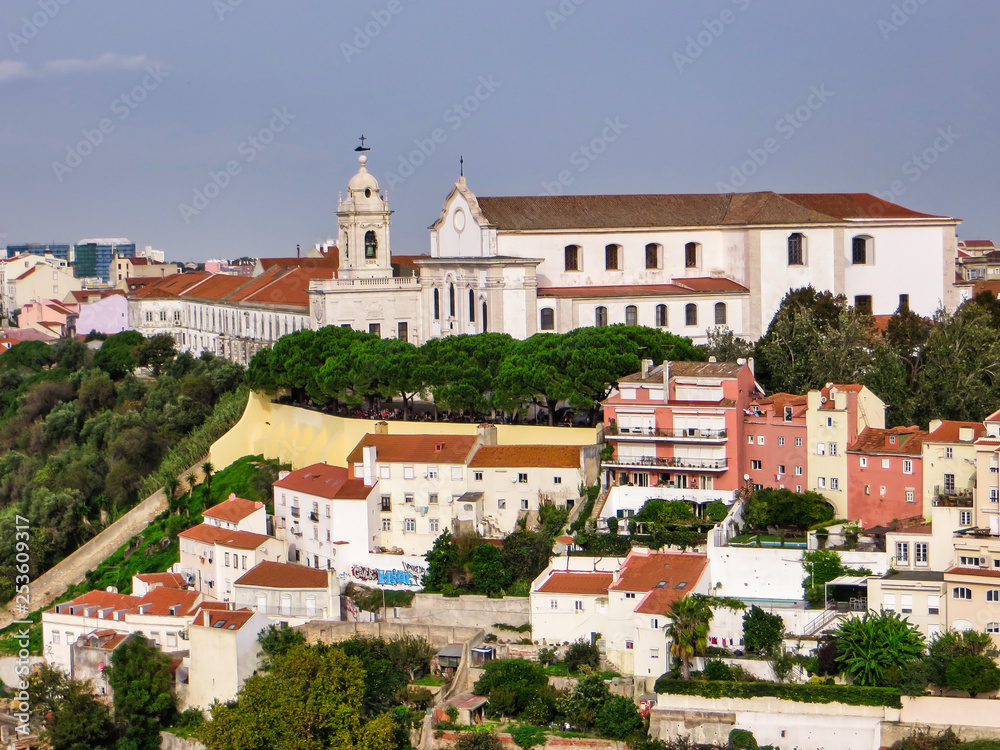 Residences in a green zone under a church in Lisbon Portugal.