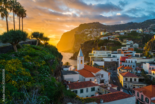 Camara de Lobos village at sunset, Cabo Girao in background, Madeira island, Portugal photo