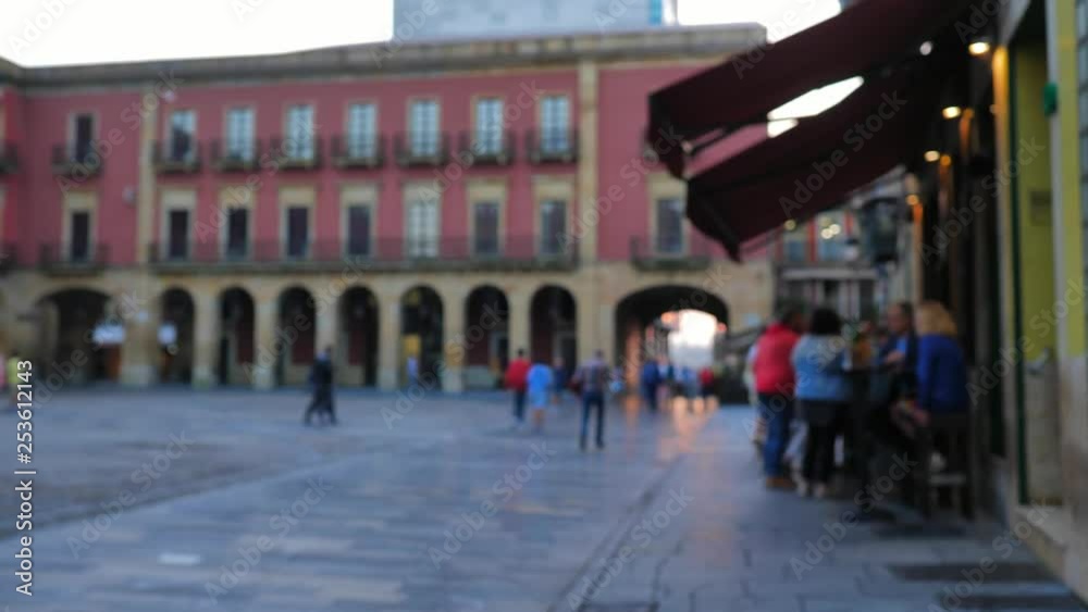 A slow-motion shot of people outdoor in the evening, in the public square of Plaza Major in Gijon, Spain. A slow-motion shot of people outdoor in the evening, in the public square of Plaza Major in Gijon, Spain.