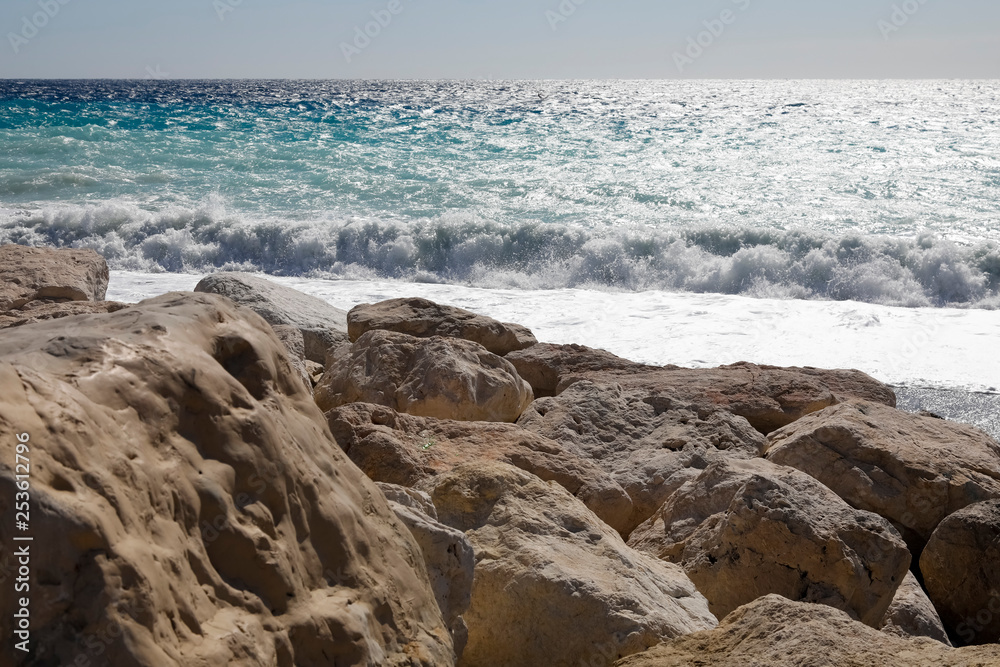Behind the stones, the Mediterranean Sea can be seen Behind the stones, the Mediterranean Sea can be seen