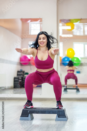 Athletic woman jumping on stepper in the gym. Exercise muscle. The concept of sports, a healthy lifestyle, losing weight © Olha Tsiplyar