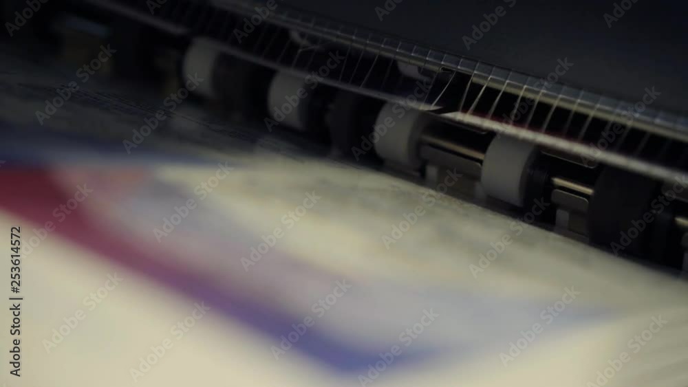 Paper printer spitting out material. Paper printer spitting out material.