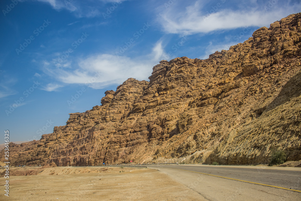 Middle East desert steep mountain rocky ridge and empty asphalt car road in vivid colorful summer season weather time country side driving trip travel photography