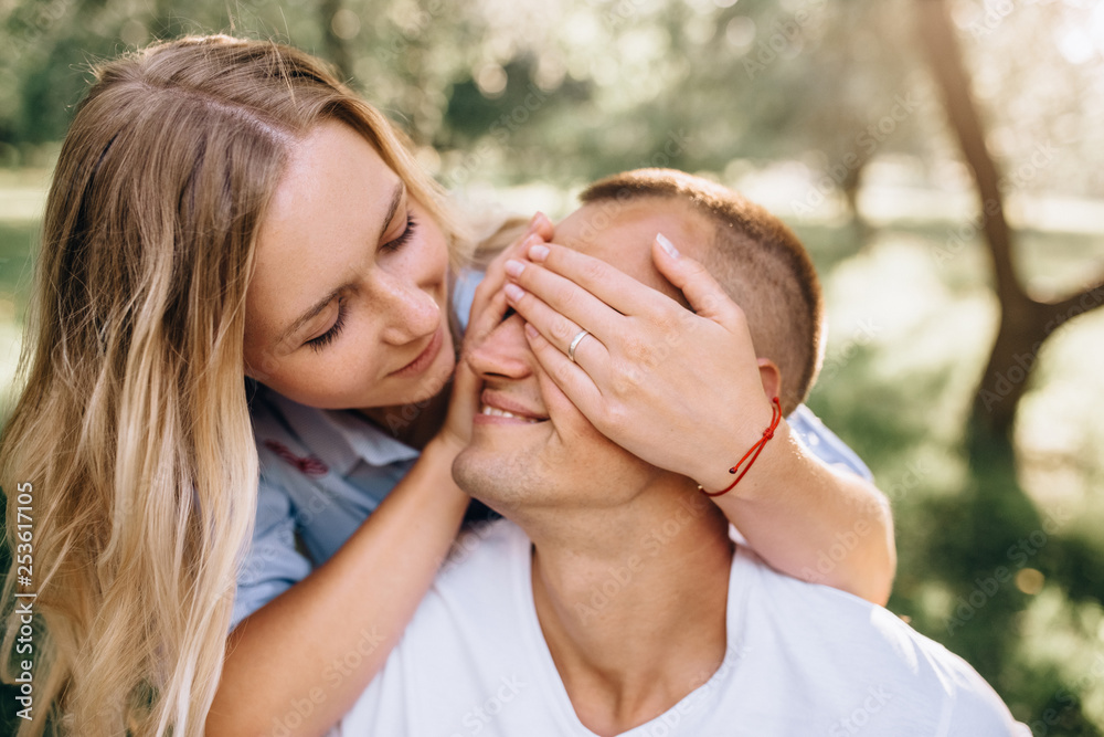 Portrait happy young smiling couple in love over flowering spring garden Portrait happy young smiling couple in love over flowering spring garden