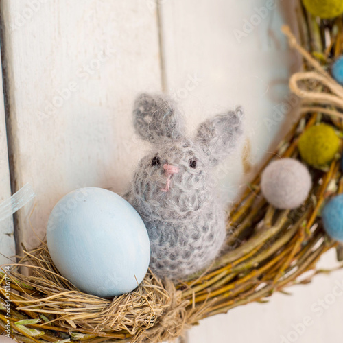 Easter decoration with a rabbit and eggs on a wreath