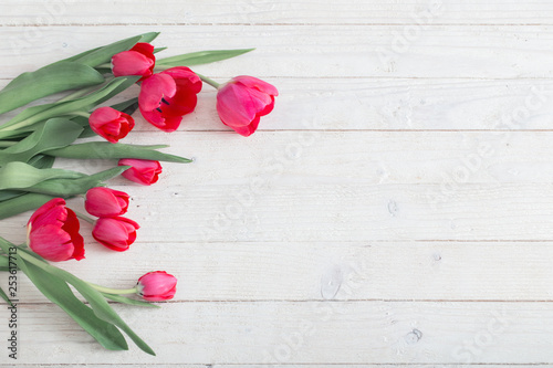 Fototapeta Naklejka Na Ścianę i Meble -  pink tulips on white wooden background