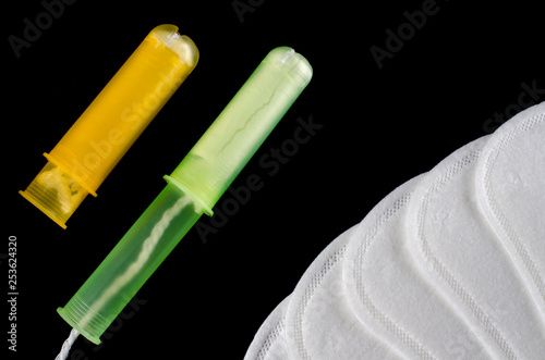 Menstrual period concept. Woman hygiene protection. Cotton tampons on black background