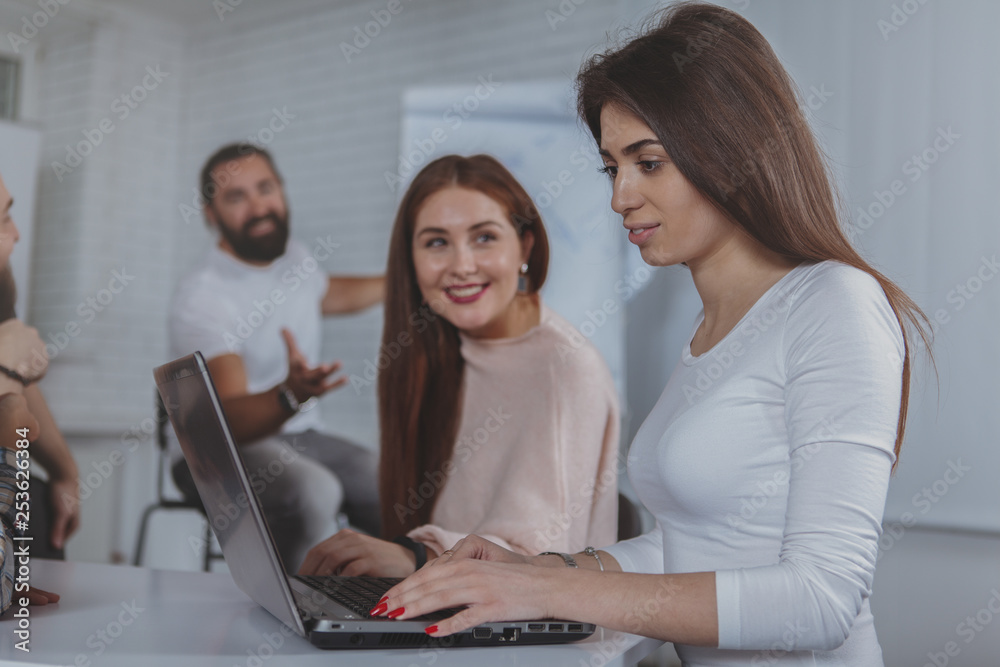 Attractive woman and her female colleague using laptop at the business meeting, copy space. Female entrepreneurs working on computer together at the office Attractive woman and her female colleague using laptop at the business meeting, copy space. Female entrepreneurs working on computer together at the office