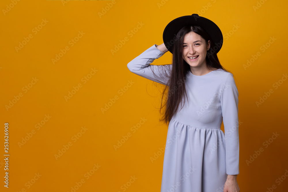 Fashion model with a fedora hat, model on a bright background, sexy brunette Fashion model with a fedora hat, model on a bright background, sexy brunette