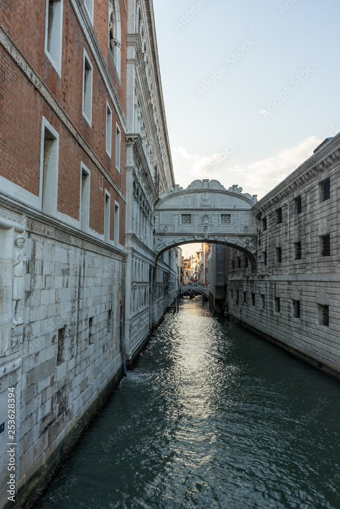 Italy, Venice, Bridge of Sighs, water next to the building with Bridge of Sighs in the background