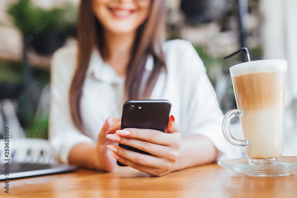 Focus on cup of latte with young girl Focus on cup of latte with young girl