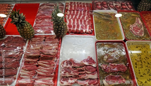 Selection of different cuts of fresh raw red meat in a supermarket 