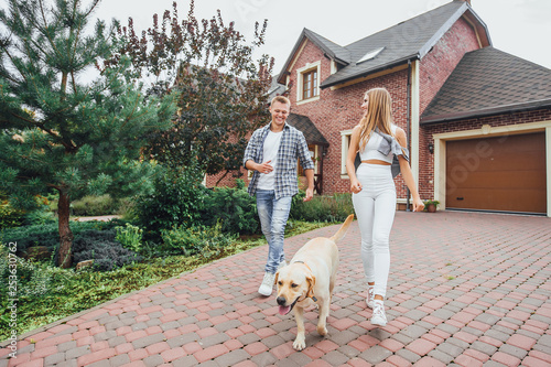 Photography Time for rest! Husband and wife spend their holidays by walking with a dog in courtyard