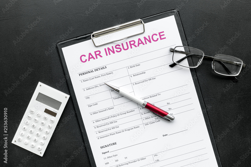 Car insurance form near glasses, calculator, pen on black background top view