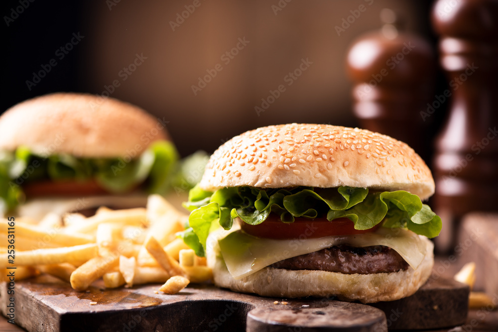 Homemade burger on wooden background.