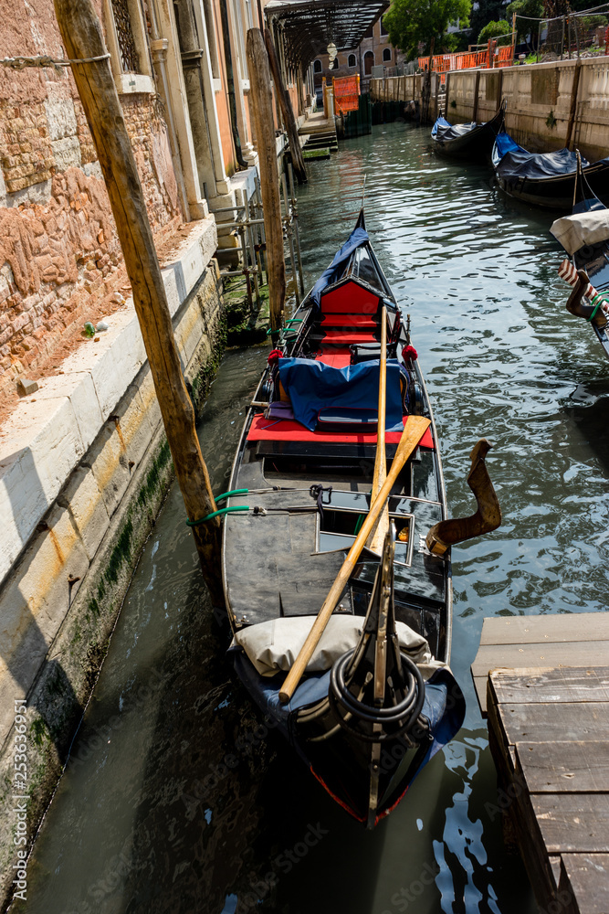 The gondolas parked near bridge in Venice, Italy