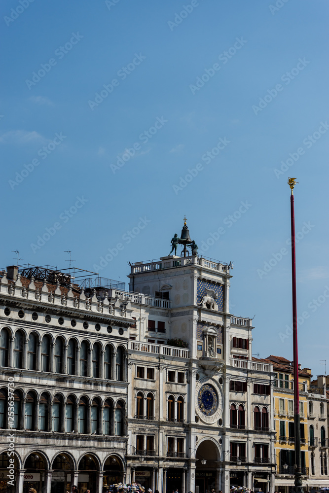 Italy, Venice, Piazza San Marco clock tower, LOW ANGLE VIEW OF BUILDING AGAINST BLUE SKY