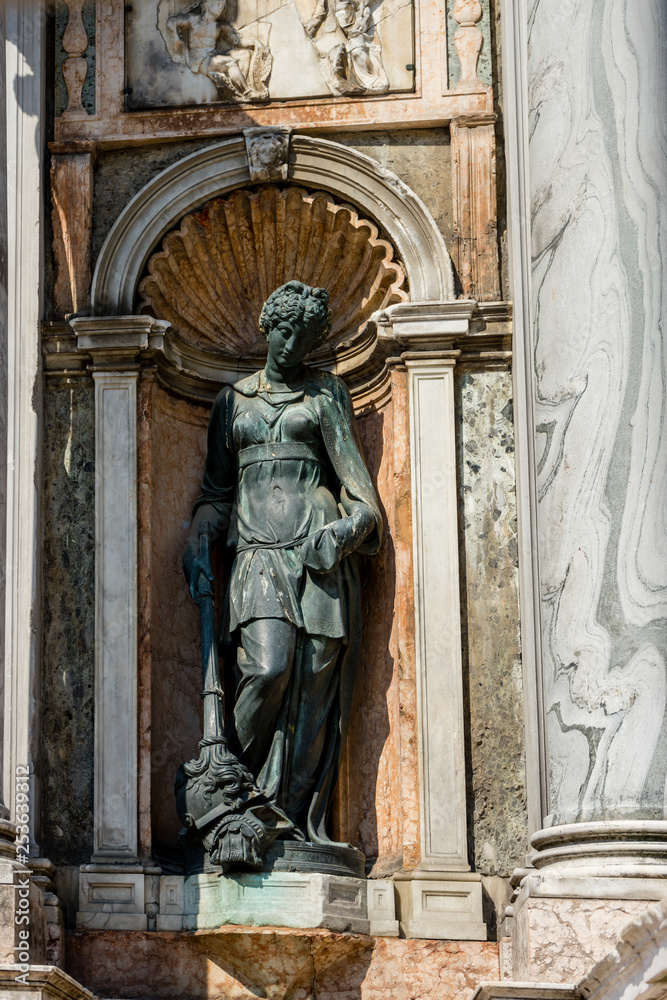 Italy, Venice, a statue in front of a door