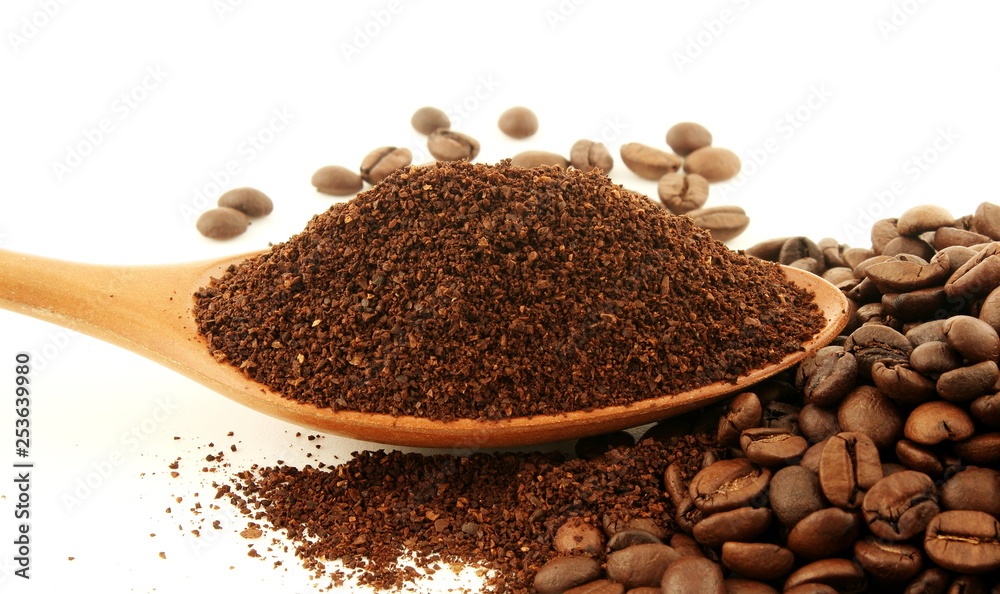 dark roasted coffee beans and ground coffee powder closeup on white background dark roasted coffee beans and ground coffee powder closeup on white background