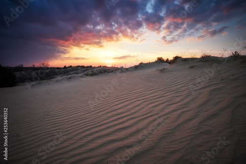 Beautiful Landscape with sunset sky and wavy sand. Composition of nature