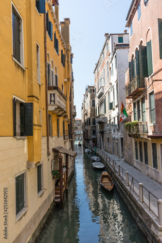 Italy, Venice, a narrow city street with buildings in the background © SkandaRamana