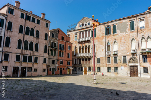 Italy, Venice, a group of people in front of a brick building