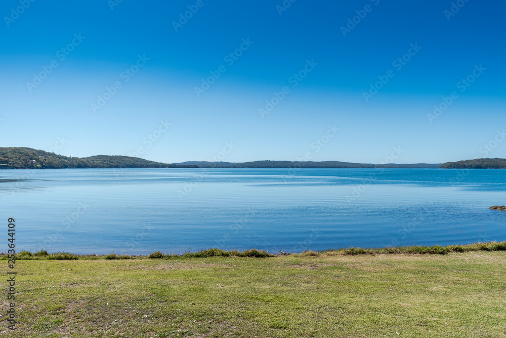 calm blue lake with clear blue sky 