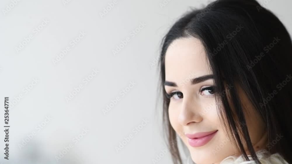 Close up portrait of woman turn around with windy hair long eyelashes happy smiling Close up portrait of woman turn around with windy hair long eyelashes happy smiling
