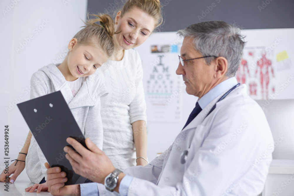 Fototapeta premium Little girl with her mother at a doctor on consultation