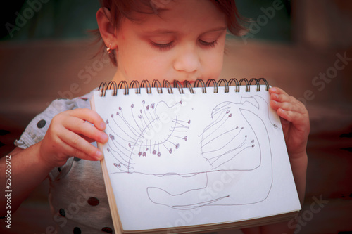 Little female little artist designer draws a pencil sketch. Creativity, art, training concept
