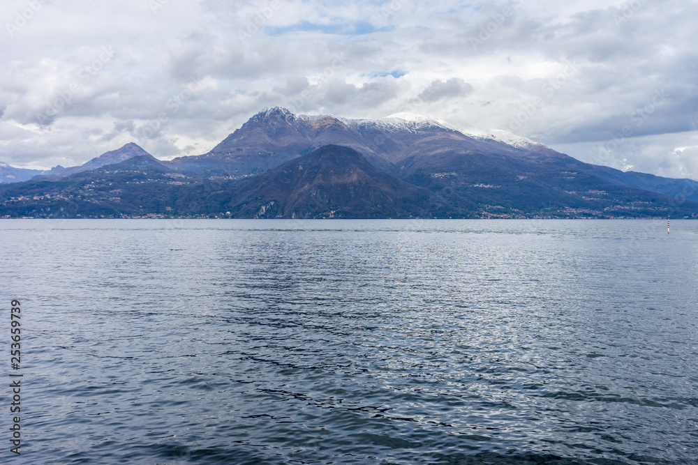 Italy, Varenna, Lake Como, a body of water with a mountain in the background