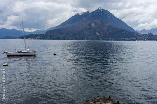 Italy, Varenna, Lake Como, Lake Atitlán, a small boat in a body of water with Lake Atitlán in the background