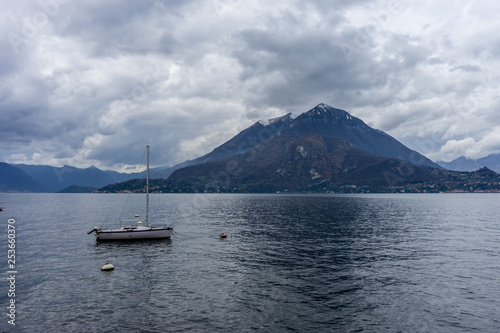 Italy, Varenna, Lake Como, Lake Atitlán, a small boat in a body of water with Lake Atitlán in the background