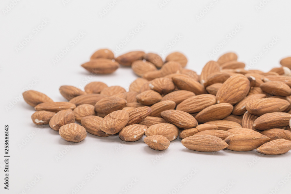 Raw natural organic close up Almonds on isolate white background.Close up Almond seeds. Raw natural organic close up Almonds on isolate white background.Close up Almond seeds.