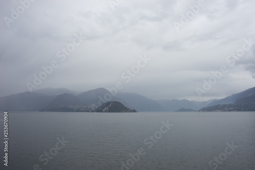 Italy, Varenna, Lake Como, a large body of water with a mountain in the background