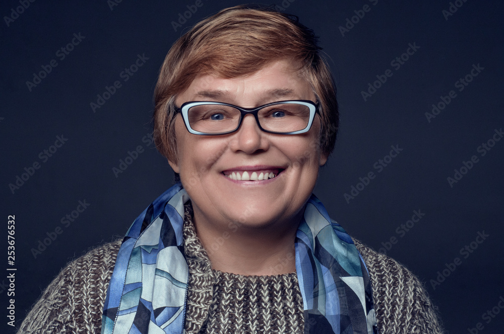 Portrait of a pensioner with glasses on a blue background Portrait of a pensioner with glasses on a blue background