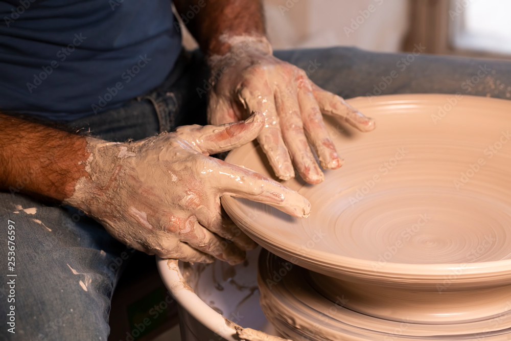 Professional potter making bowl in pottery workshop Professional potter making bowl in pottery workshop