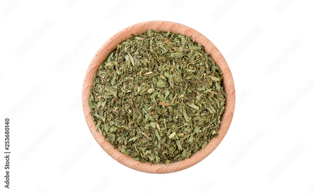 tarragon herb in wooden bowl isolated on white background. Spices and food ingredients. tarragon herb in wooden bowl isolated on white background. Spices and food ingredients.