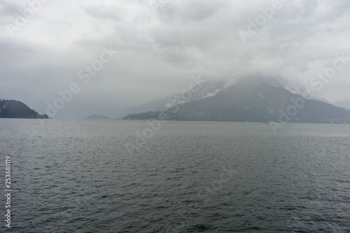 Italy, Varenna, Lake Como, a body of water with a mountain in the background